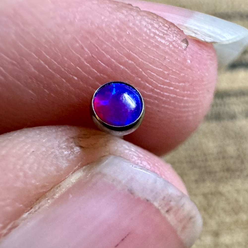 16g stud with blue/purple opalized stone.